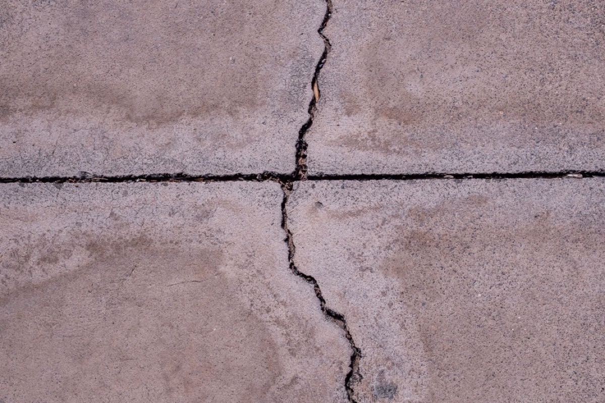 Close-up of a crack running across a concrete floor surface
